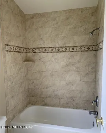 a view of backyard with green space and wooden fence