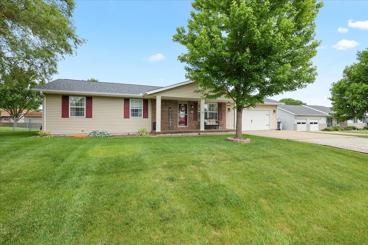a front view of house with yard and green space