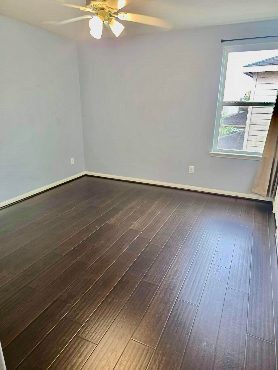 11207 Hall Ridge Court Houston, TX 77075 - Photo 12 of 16 a view of an empty room with wooden floor and a window