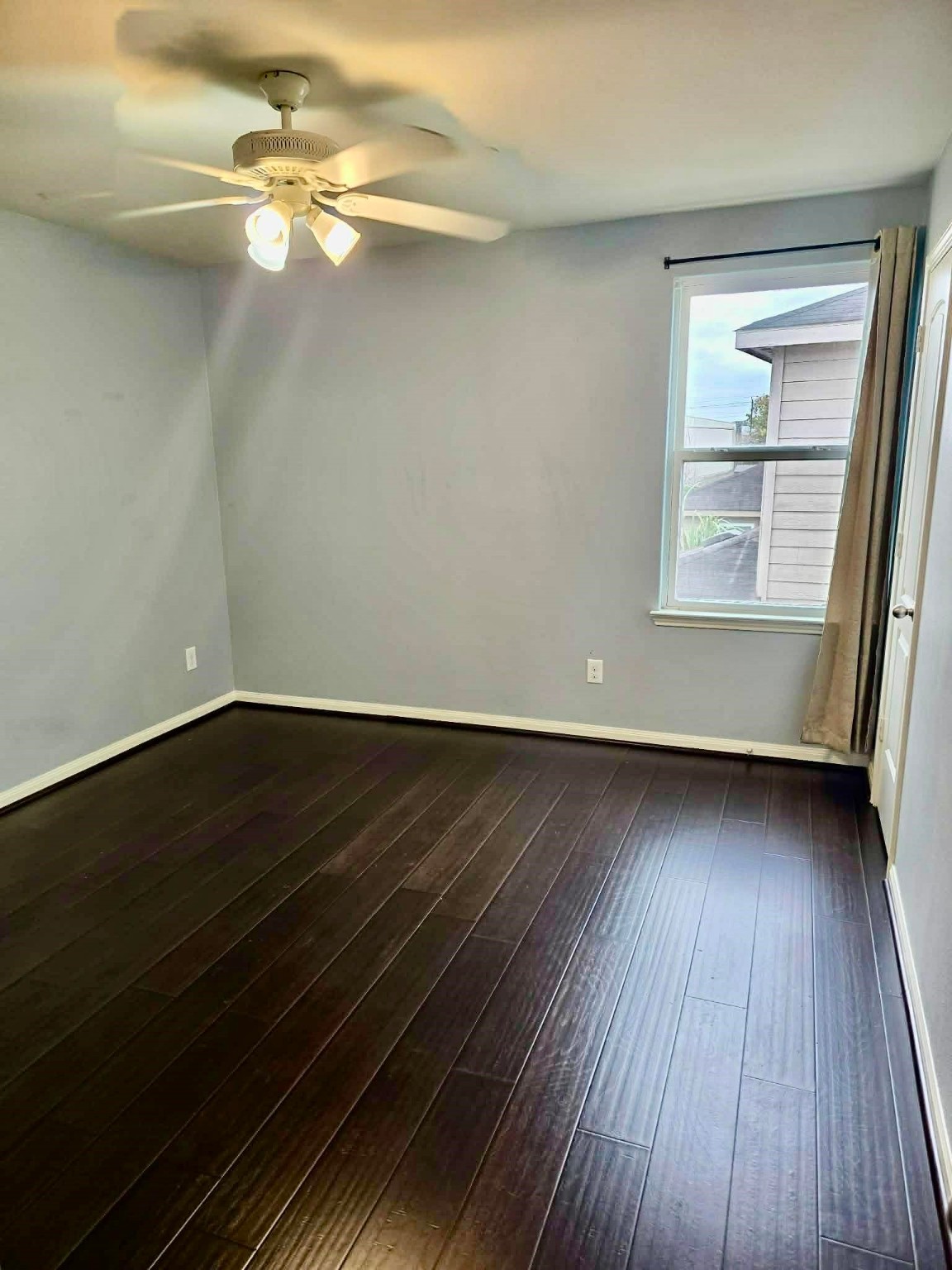 11207 Hall Ridge Court Houston, TX 77075 - Photo 14 of 16 a view of a room with wooden floor and fan