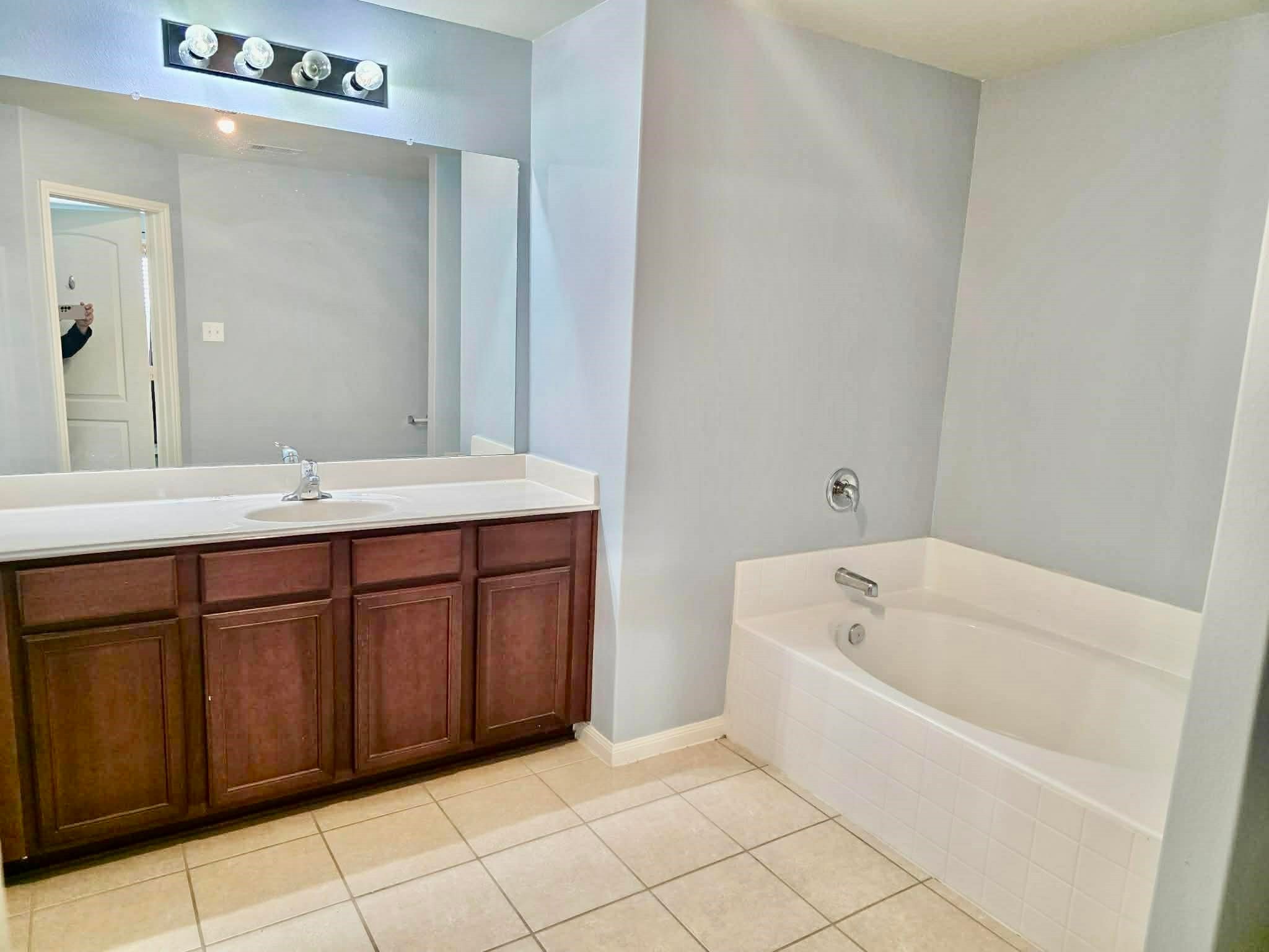 11207 Hall Ridge Court Houston, TX 77075 - Photo 9 of 16 a bathroom with a bathtub sink and mirror
