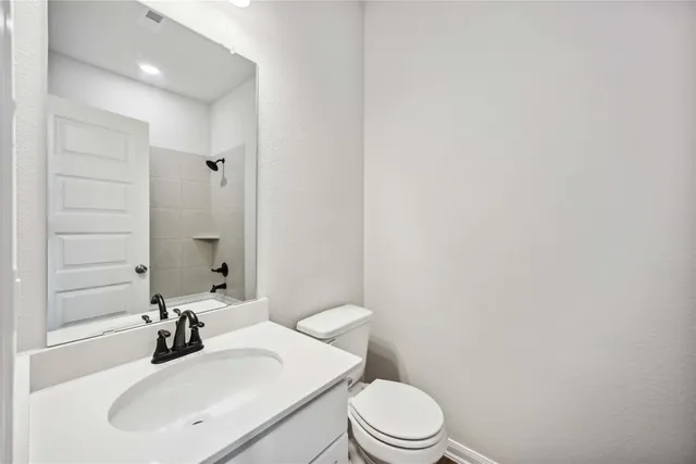 a bathroom with a sink a toilet and mirror