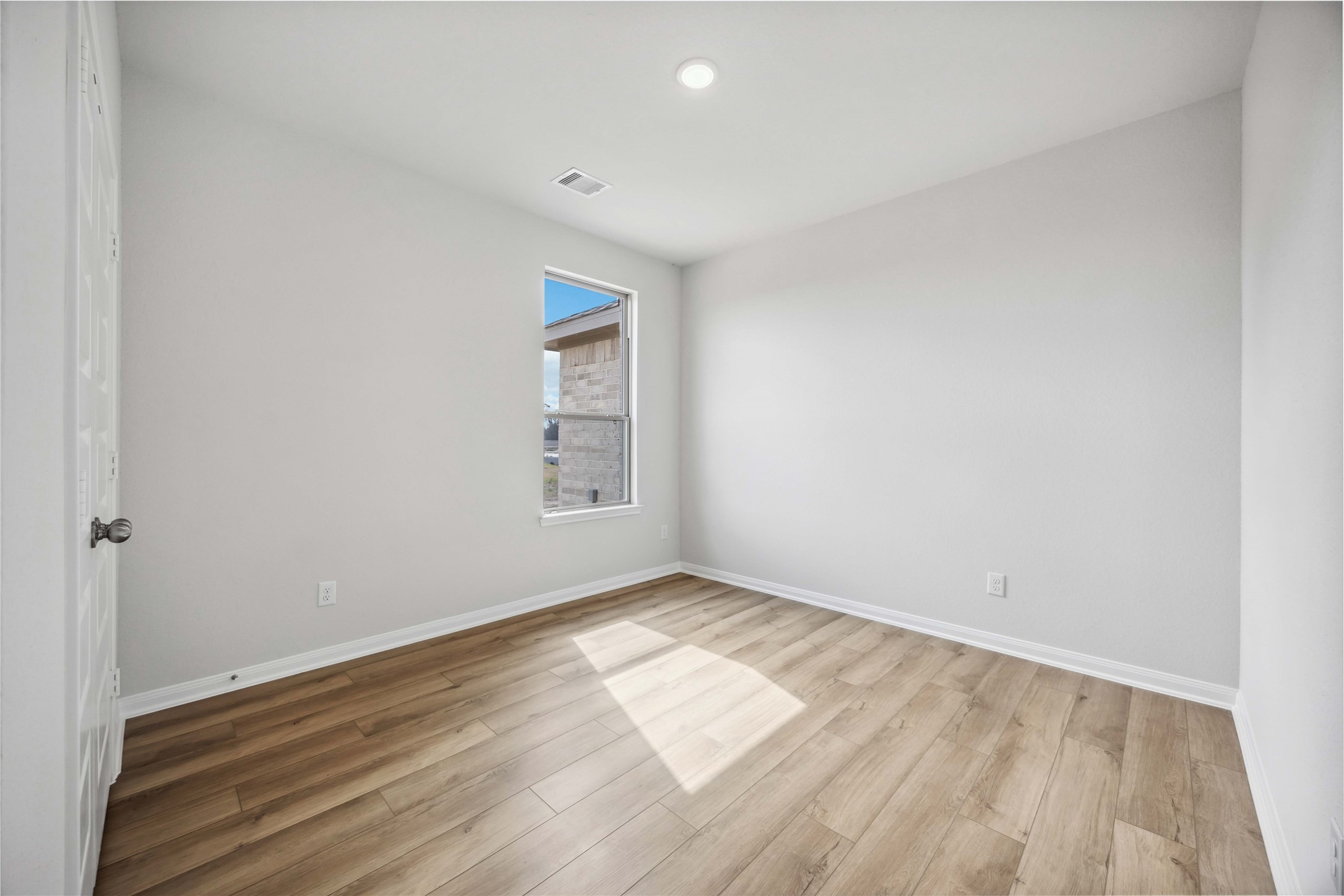 9519 Sweet Tea Lane Needville, TX 77461 - Photo 14 of 35 an empty room with wooden floor and windows