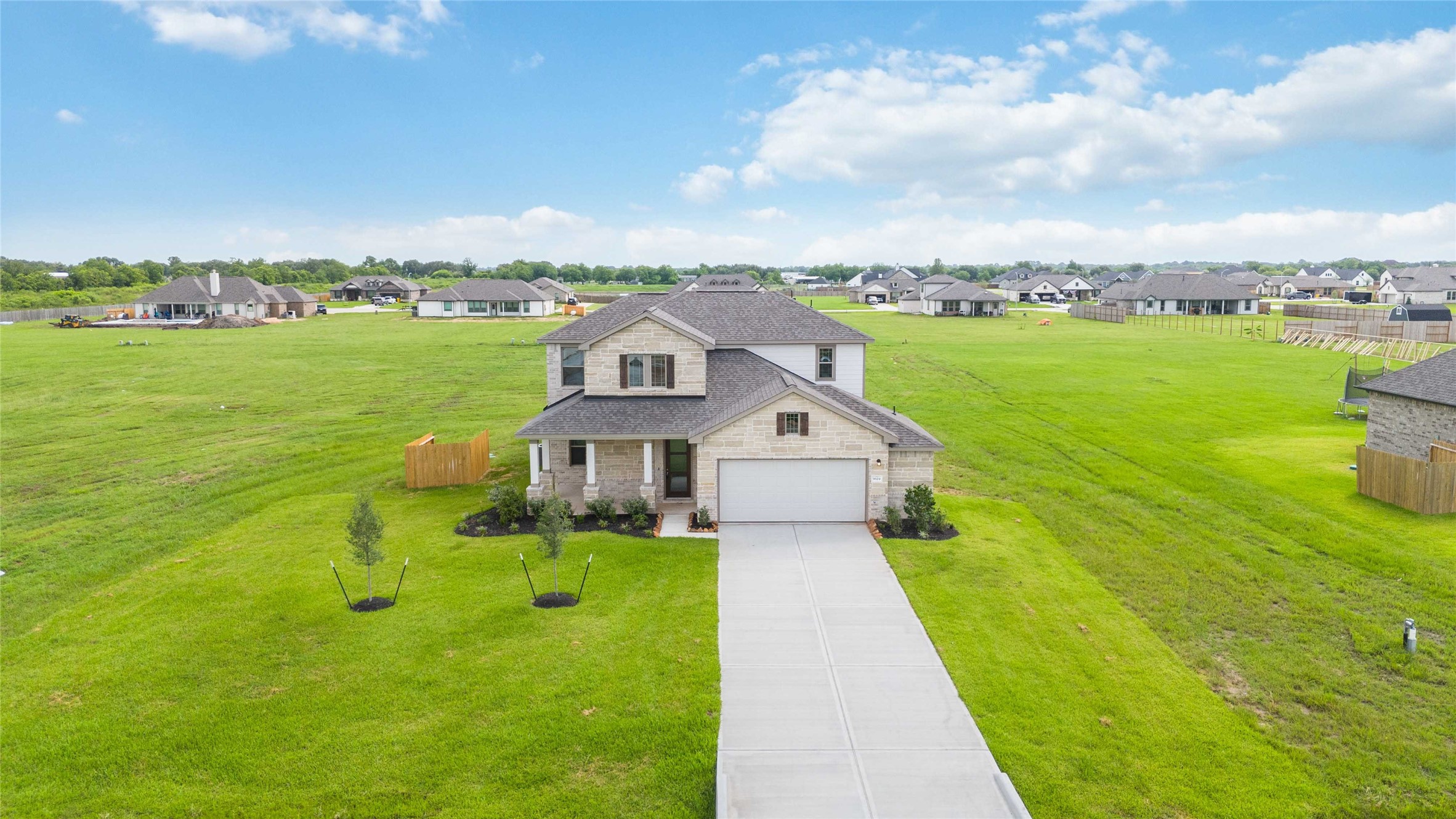 9519 Sweet Tea Lane Needville, TX 77461 - Photo 29 of 35 a view of a house with a big yard and potted plants in front of it