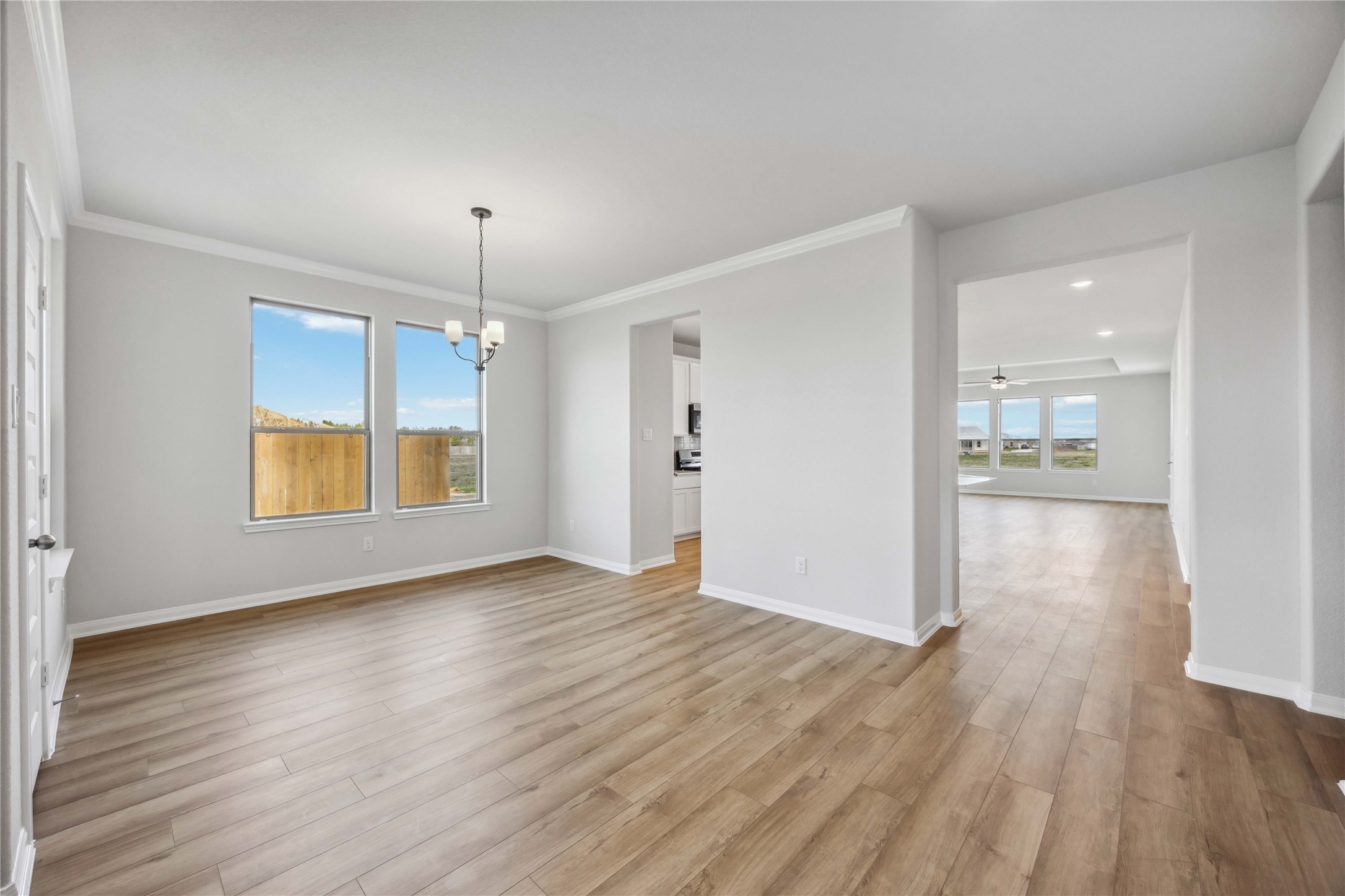 9519 Sweet Tea Lane Needville, TX 77461 - Photo 3 of 35 an empty room with wooden floor and windows