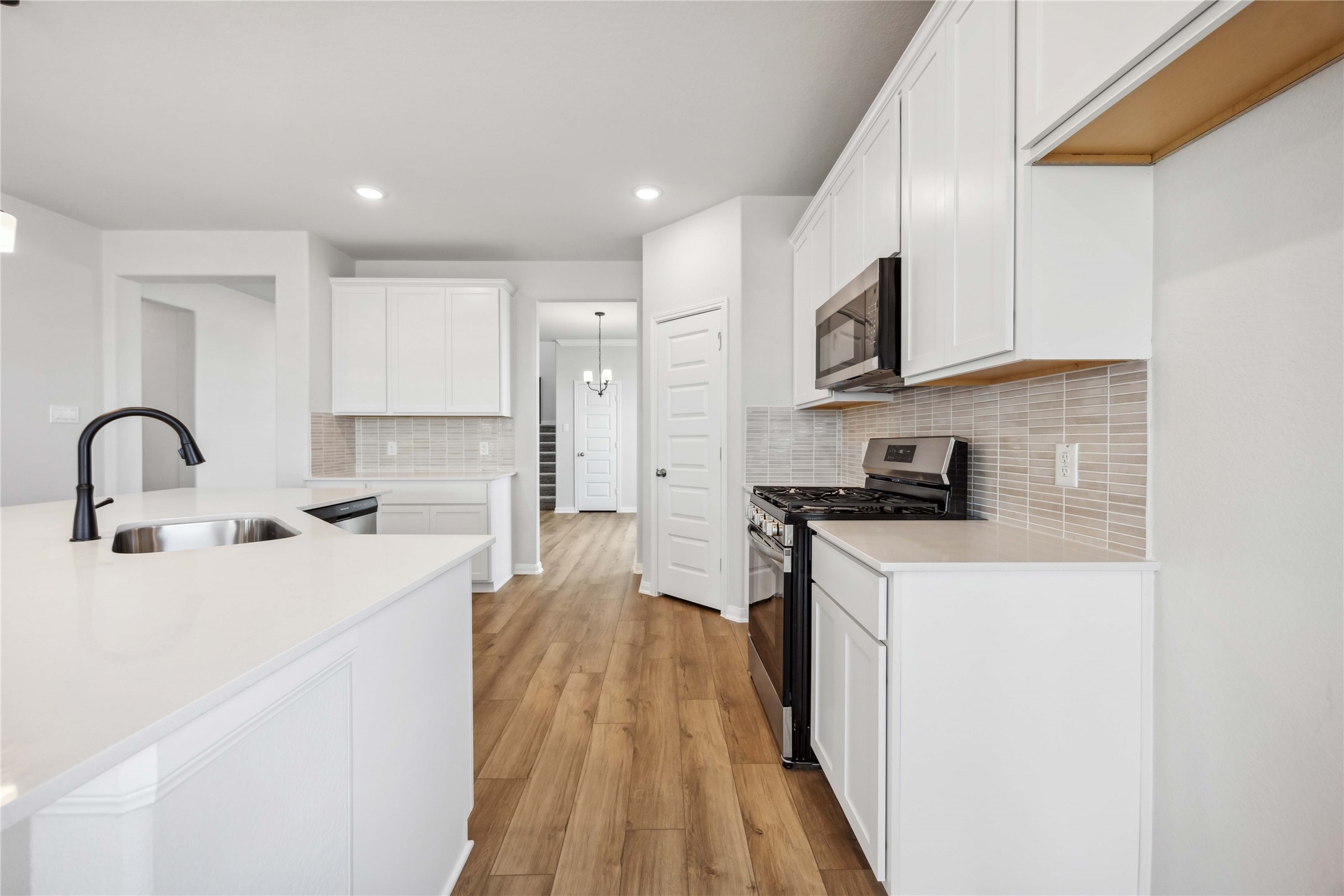 9519 Sweet Tea Lane Needville, TX 77461 - Photo 5 of 35 a kitchen with stainless steel appliances granite countertop a stove a sink and a refrigerator