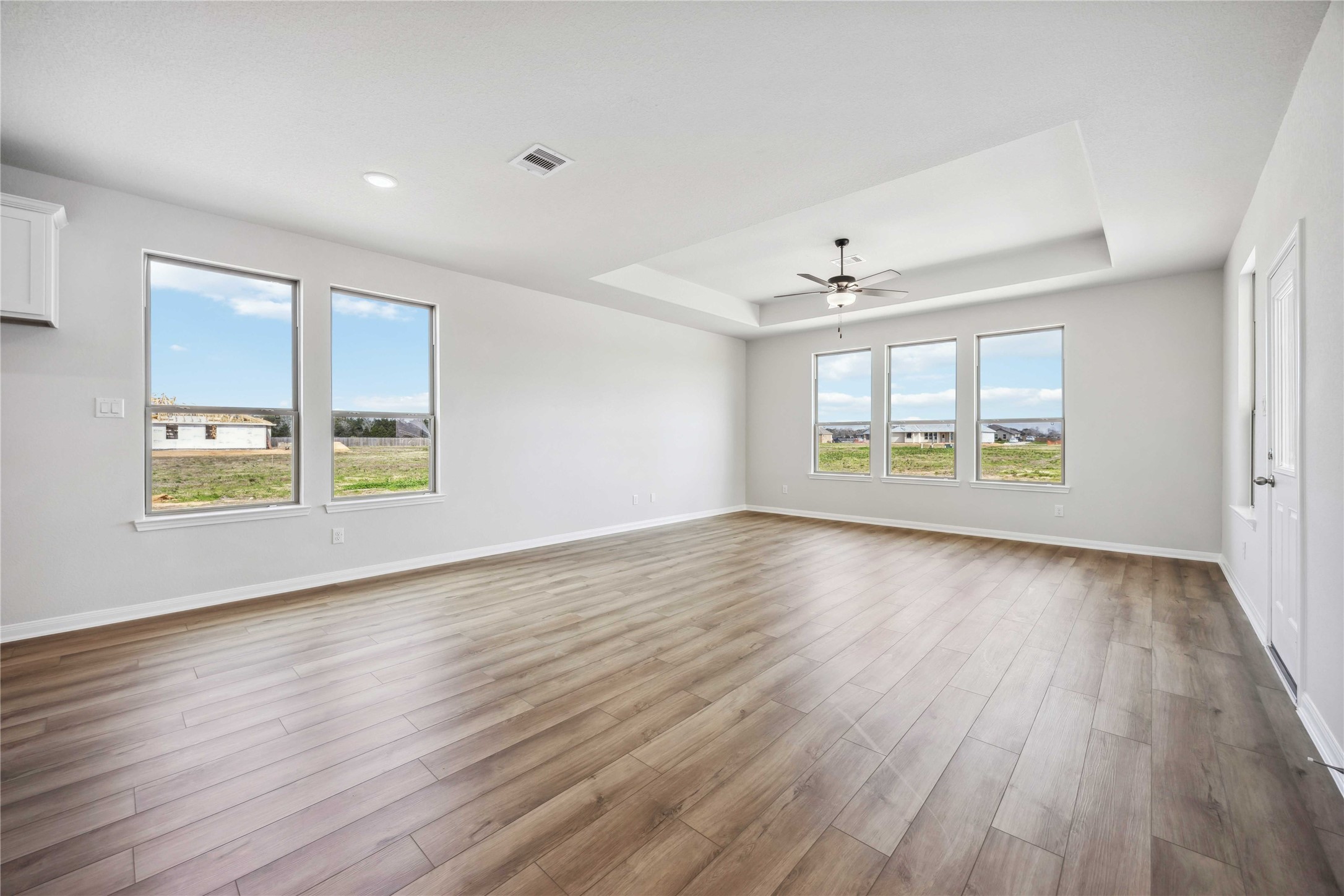 9519 Sweet Tea Lane Needville, TX 77461 - Photo 8 of 35 an empty room with wooden floor and windows
