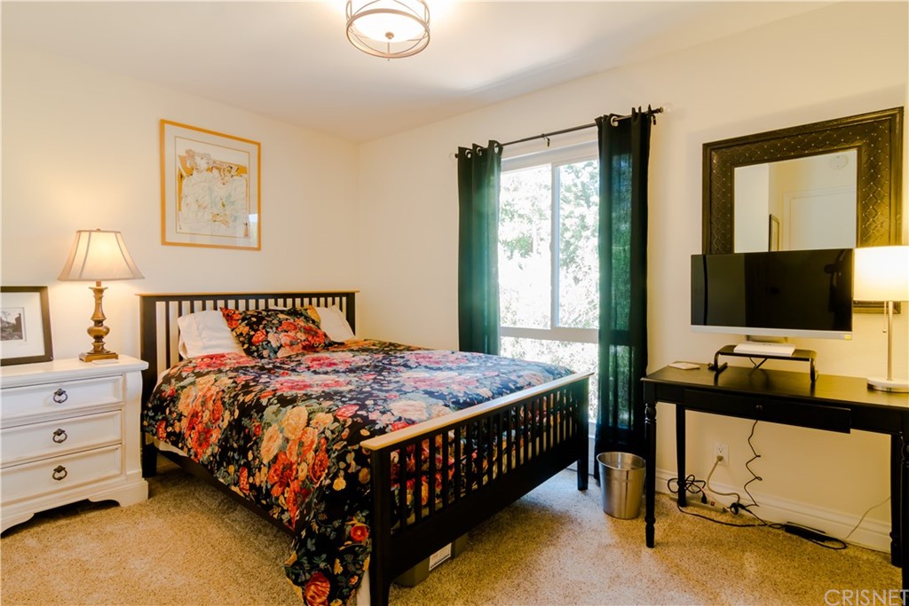 27462 Country Glen Road Agoura Hills, CA 91301 - Photo 13 of 19 a bedroom with a bed and a flat tv screen on dresser