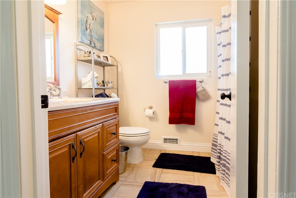 27462 Country Glen Road Agoura Hills, CA 91301 - Photo 14 of 19 a bathroom with a sink a toilet a window and shower