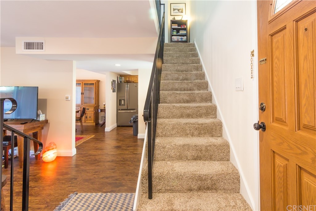 27462 Country Glen Road Agoura Hills, CA 91301 - Photo 4 of 19 a view of a hallway with wooden floor and staircase