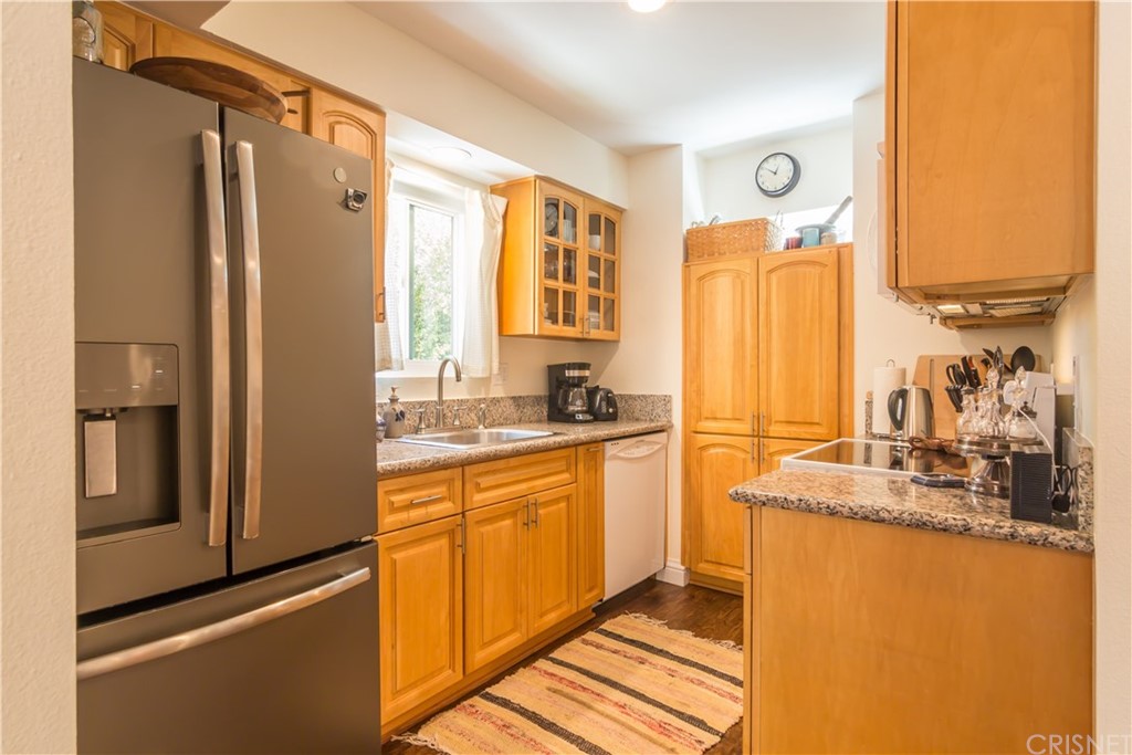27462 Country Glen Road Agoura Hills, CA 91301 - Photo 8 of 19 a kitchen with stainless steel appliances granite countertop a refrigerator and a sink