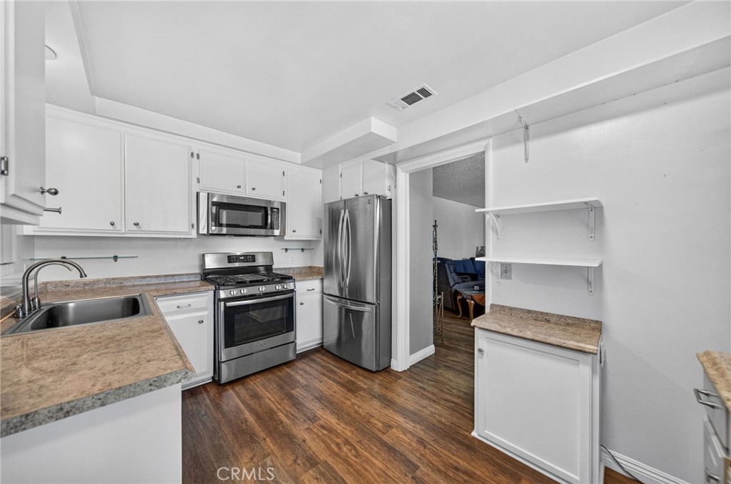 29078 Bradley Road Menifee, CA 92586 - Photo 17 of 42 a kitchen with a refrigerator stove and sink