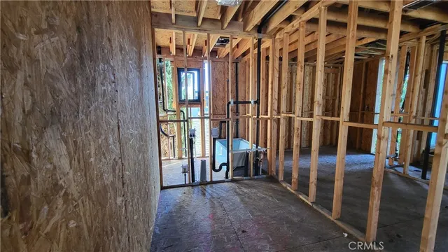 a view of a room with wooden walls and windows
