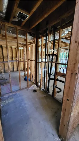 a view of a room with wooden floor and iron stairs