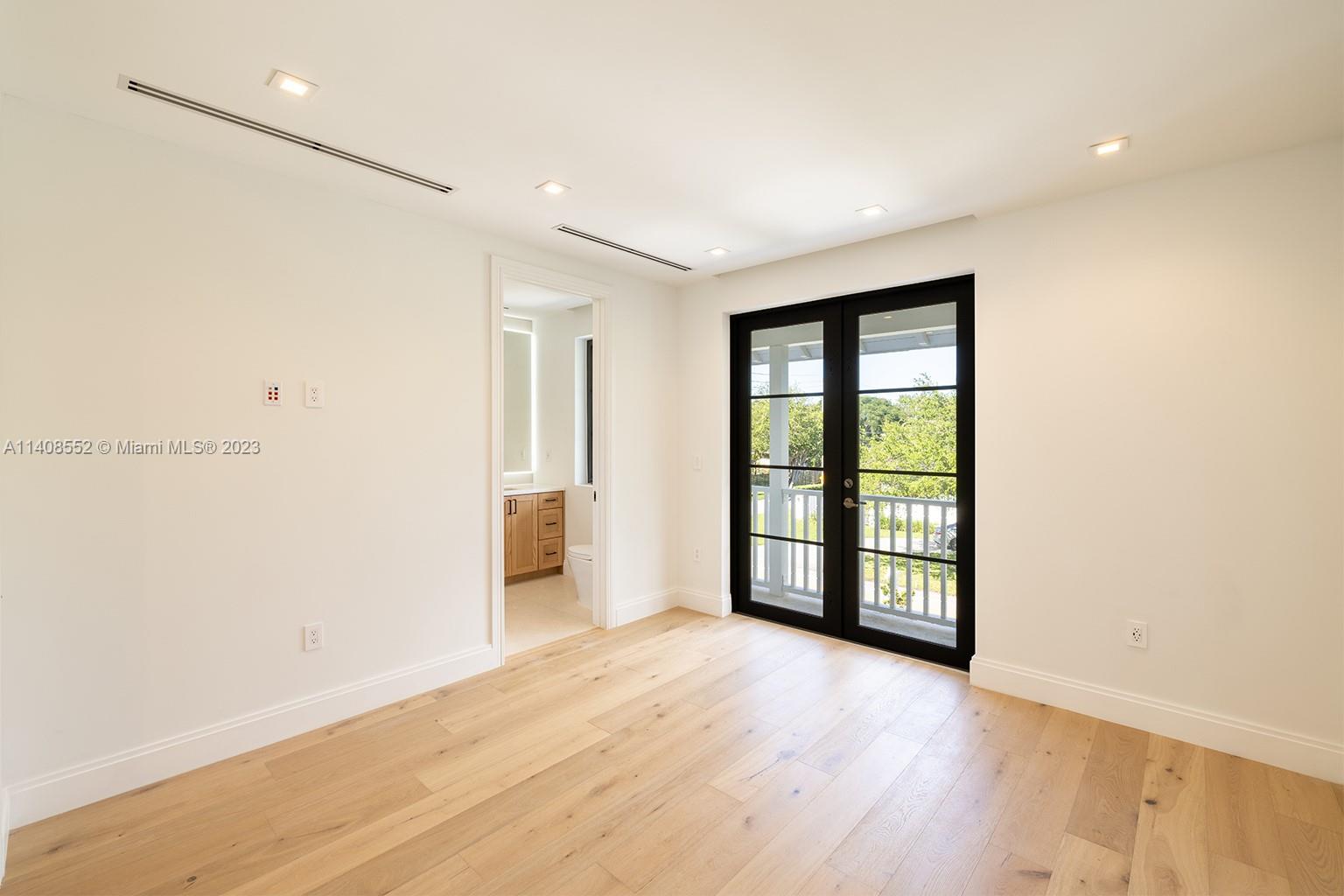 5500 Southwest 74th Street Miami, FL 33143 - Photo 17 of 31 wooden floor in an empty room with a window
