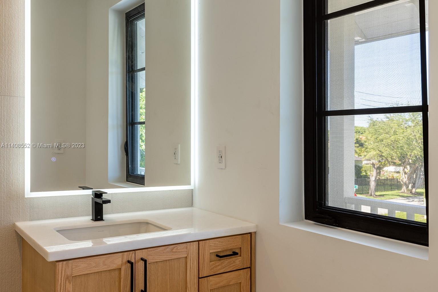 5500 Southwest 74th Street Miami, FL 33143 - Photo 18 of 31 a bathroom with a sink and a mirror