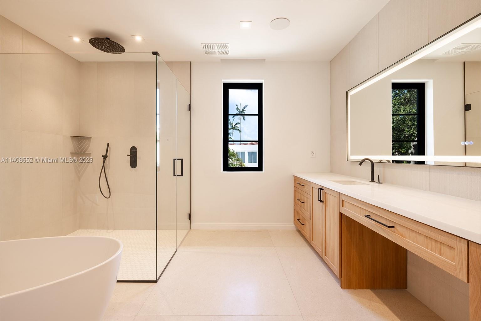 5500 Southwest 74th Street Miami, FL 33143 - Photo 21 of 31 a spacious bathroom with a tub sink shower and mirror