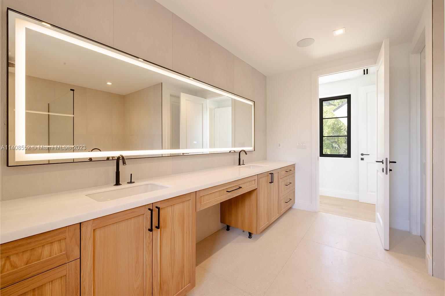 5500 Southwest 74th Street Miami, FL 33143 - Photo 23 of 31 a large bathroom with a double vanity sink and a mirror