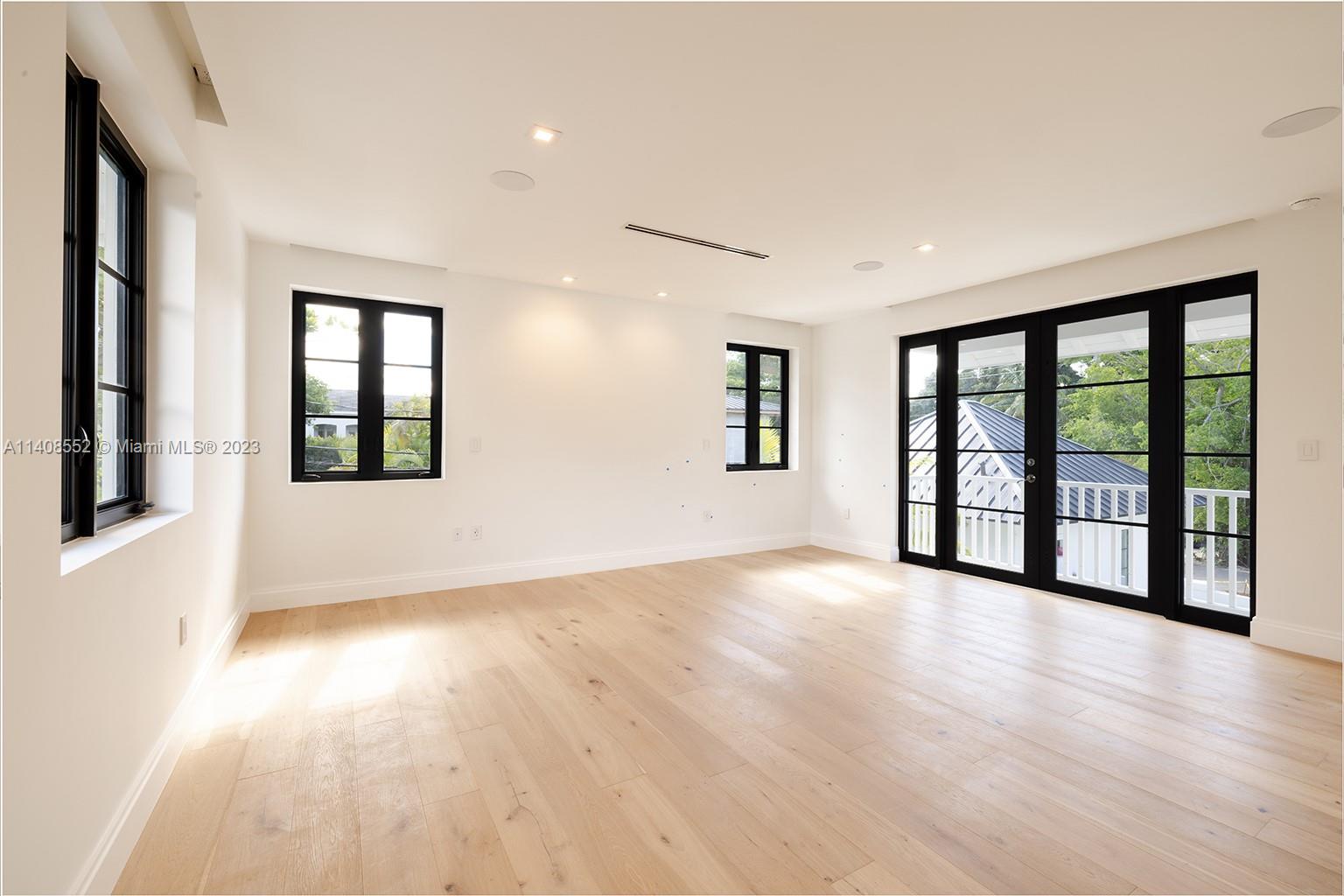 5500 Southwest 74th Street Miami, FL 33143 - Photo 25 of 31 wooden floor in an empty room with a window