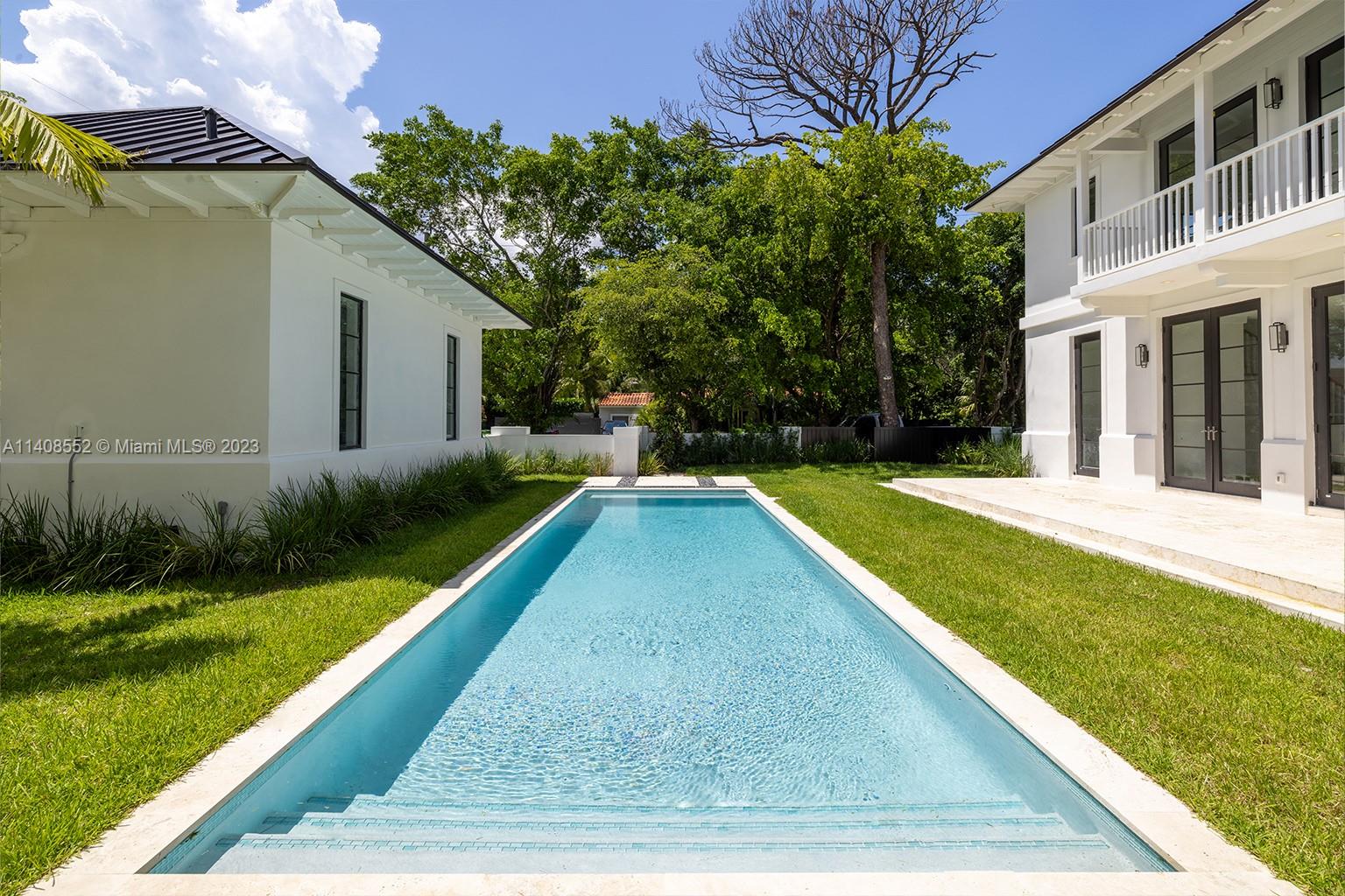 5500 Southwest 74th Street Miami, FL 33143 - Photo 29 of 31 a view of swimming pool with a garden