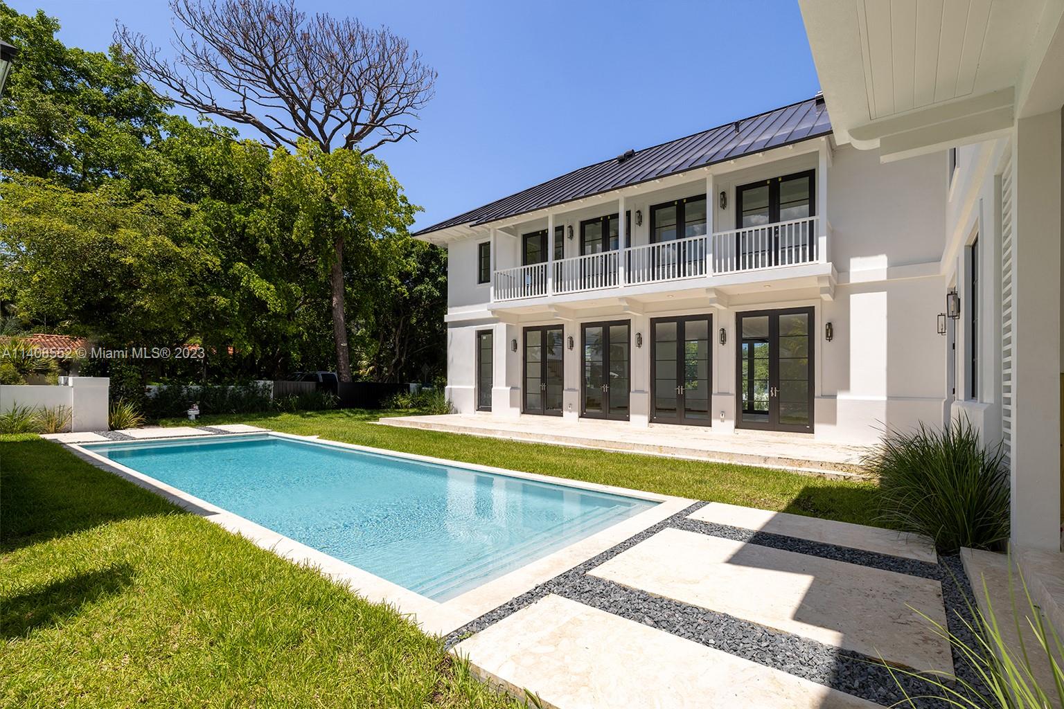 5500 Southwest 74th Street Miami, FL 33143 - Photo 30 of 31 a view of a swimming pool with a house in the background