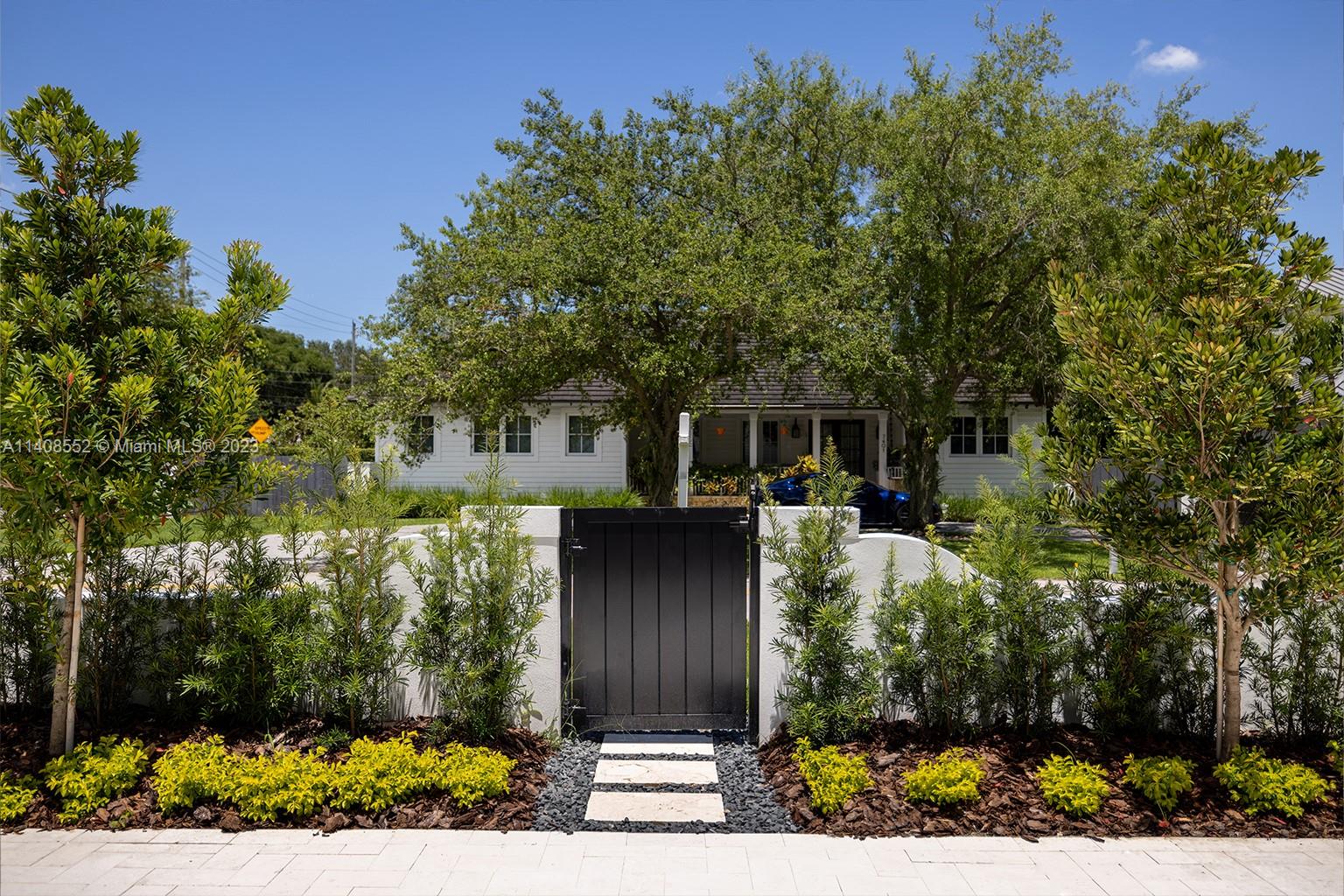5500 Southwest 74th Street Miami, FL 33143 - Photo 6 of 31 a front view of a house with a yard