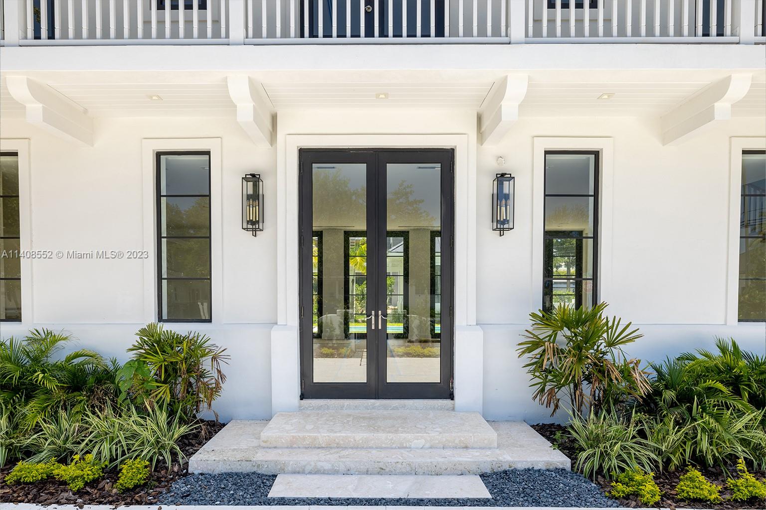 5500 Southwest 74th Street Miami, FL 33143 - Photo 7 of 31 a front view of a house with a glass door