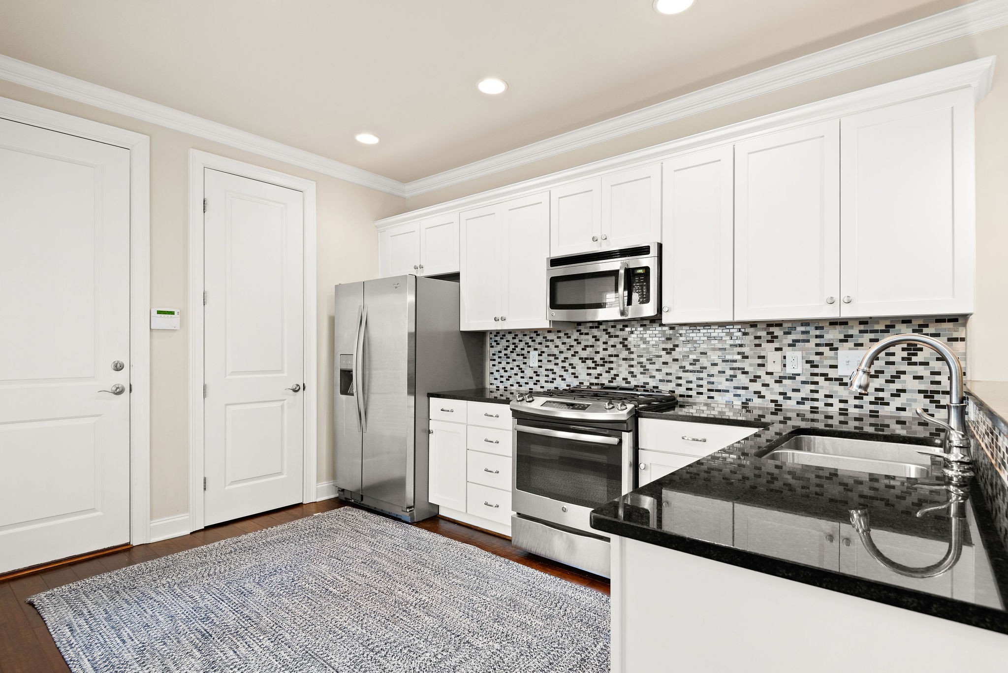 1031 Howland Street Franklin, TN 37064 - Photo 18 of 69 a kitchen with granite countertop a stove and a microwave