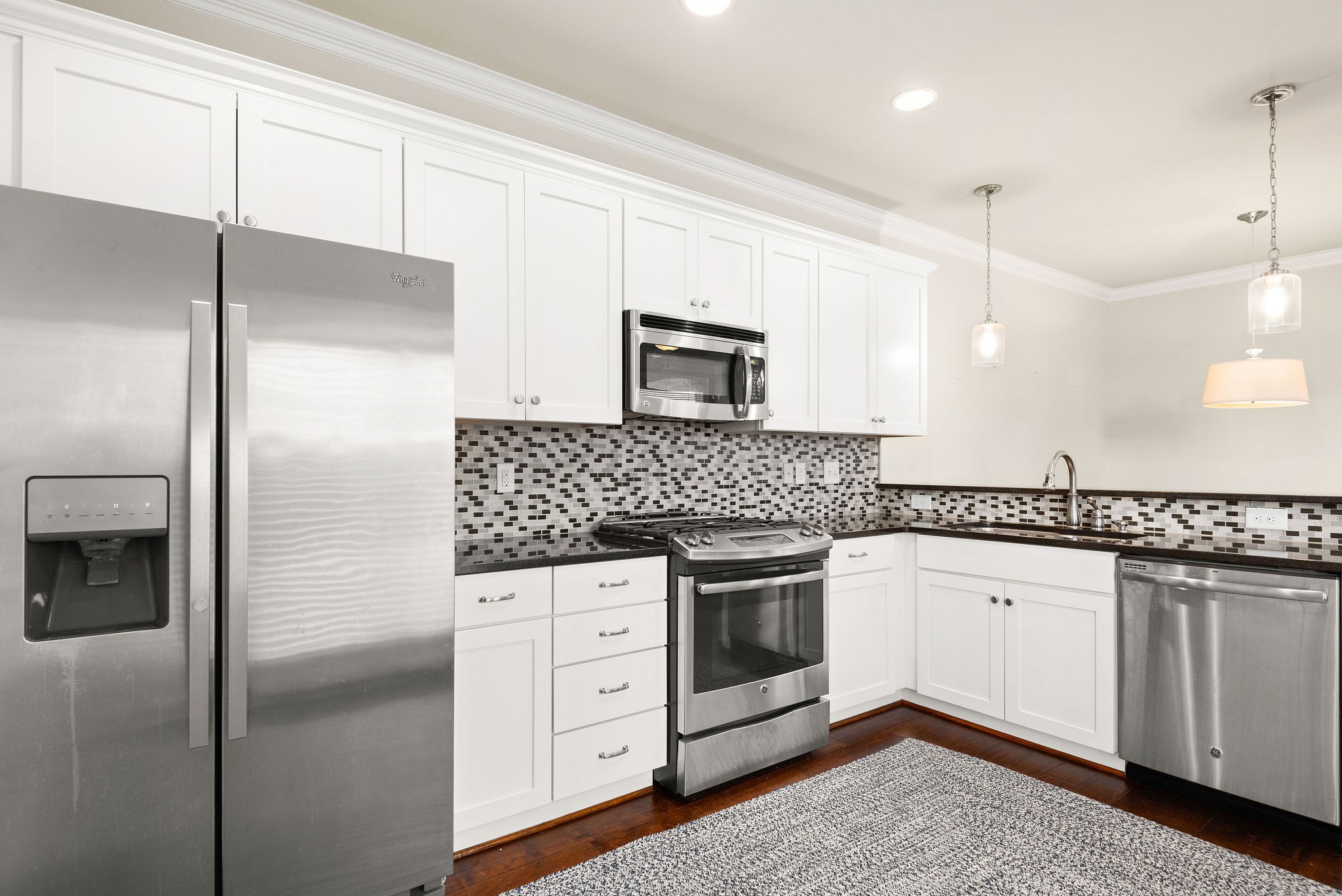 1031 Howland Street Franklin, TN 37064 - Photo 20 of 69 a kitchen with granite countertop a refrigerator sink and cabinets