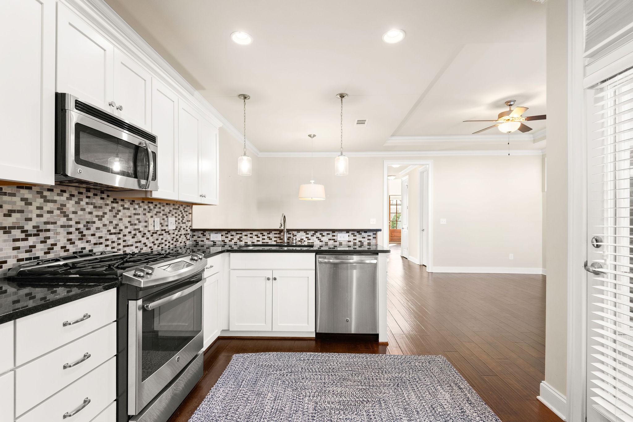 1031 Howland Street Franklin, TN 37064 - Photo 21 of 69 a kitchen with stainless steel appliances granite countertop a stove and a microwave