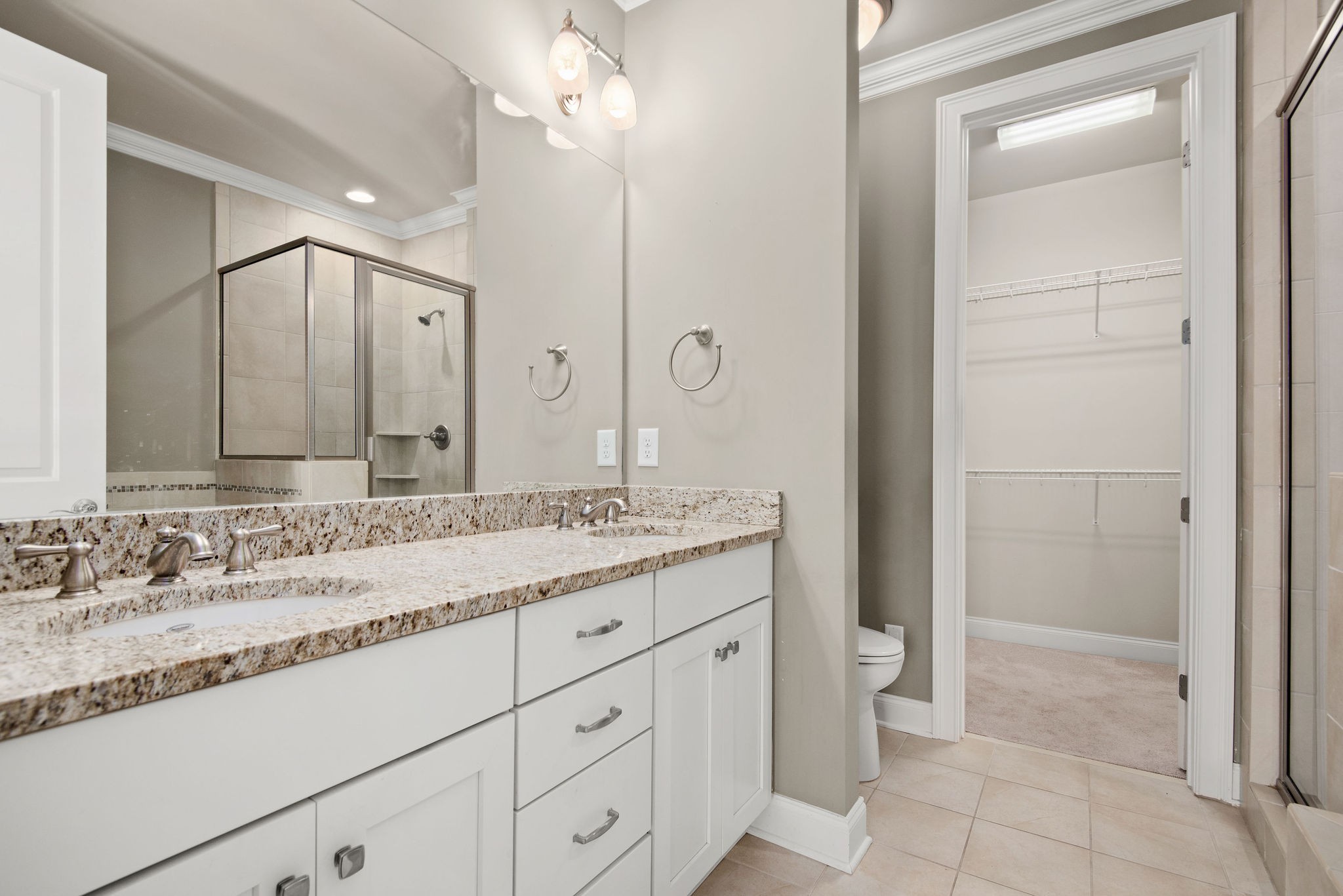 1031 Howland Street Franklin, TN 37064 - Photo 25 of 69 a bathroom with a granite countertop sink a mirror and a shower