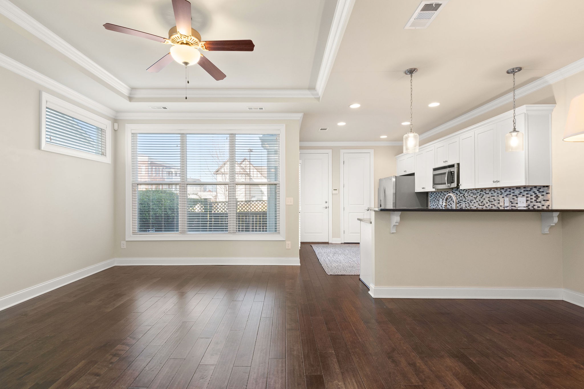 1031 Howland Street Franklin, TN 37064 - Photo 10 of 69 a view of an empty room with wooden floor and a window