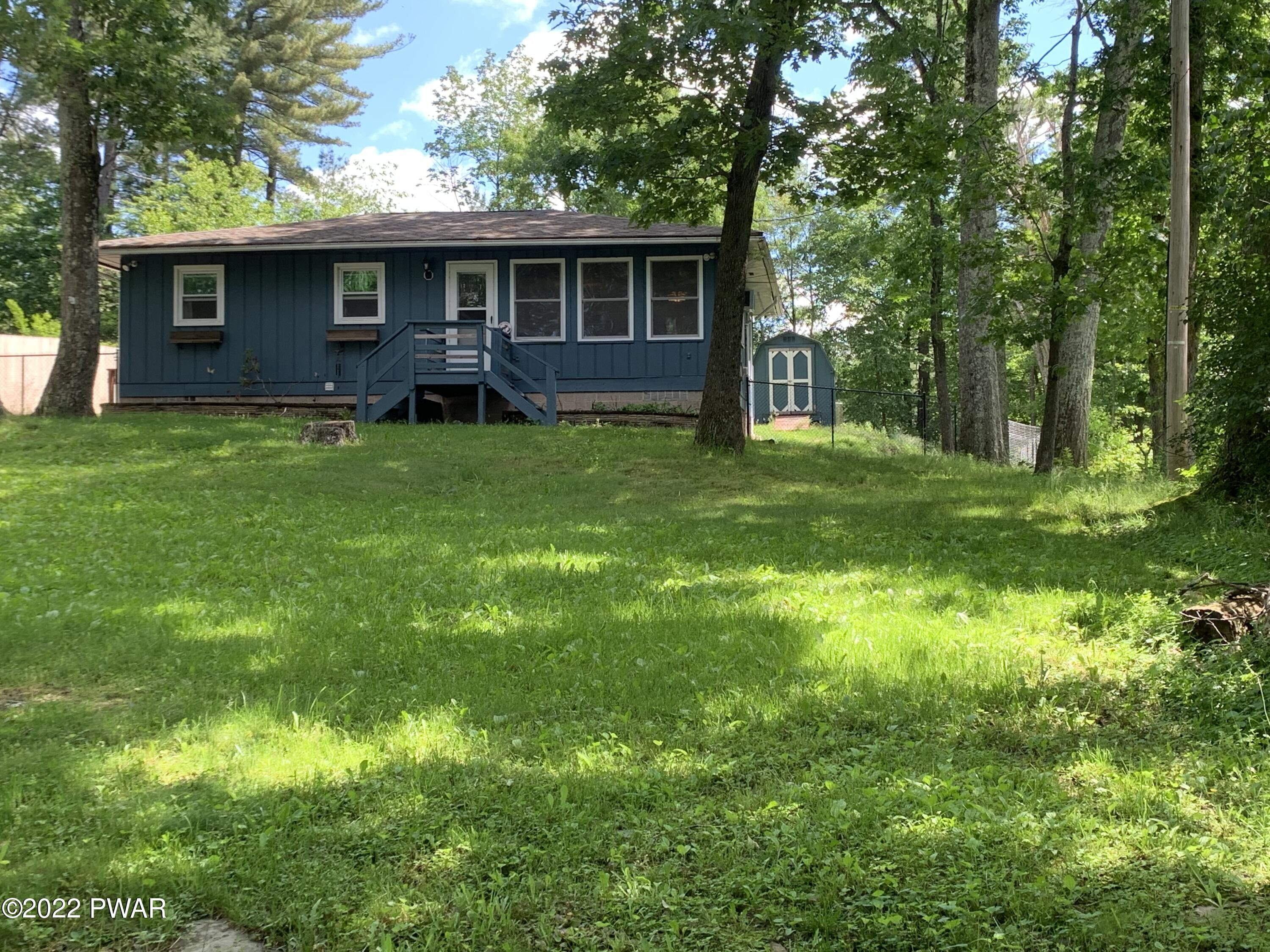 a front view of house with yard and green space