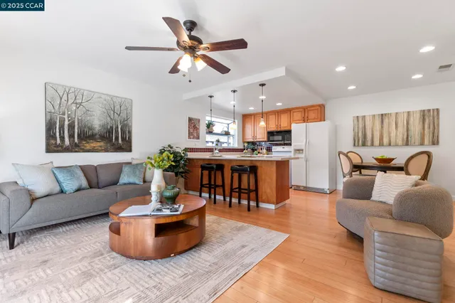 a living room with furniture and kitchen view