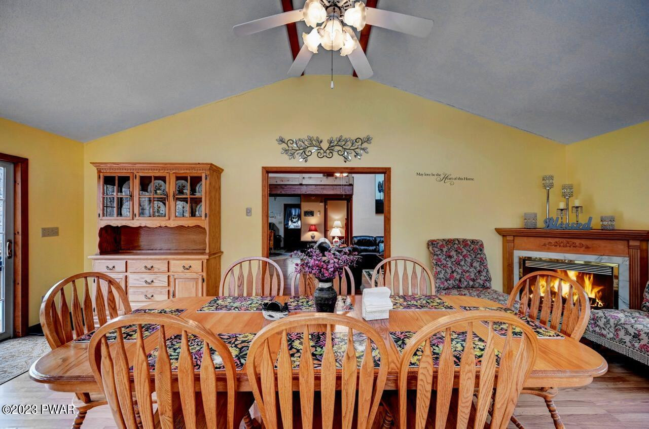 413 Northgate Road Lake Ariel, PA 18436 - Photo 15 of 59 a view of a dining room with furniture chandelier and wooden floor