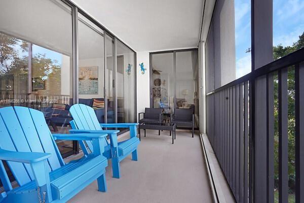 1605 Highway 1, Unit 403M3 Jupiter, FL 33477 - Photo 14 of 18 a living room with furniture and a floor to ceiling window