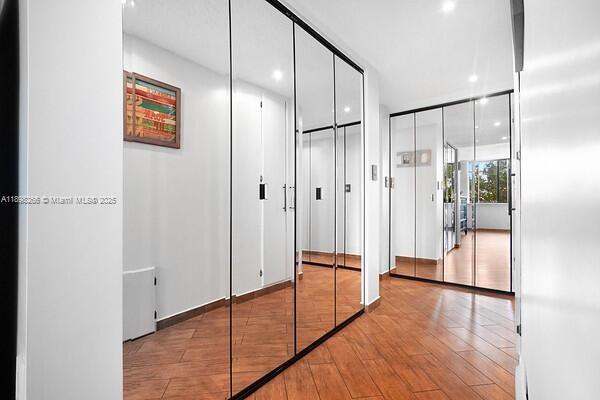 1605 Highway 1, Unit 403M3 Jupiter, FL 33477 - Photo 16 of 18 a view of a hallway with wooden floor and staircase