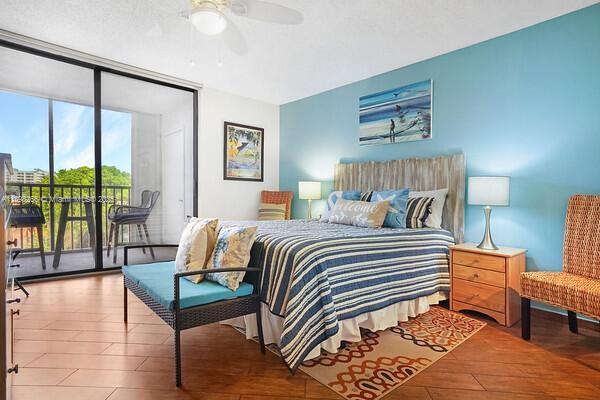 1605 Highway 1, Unit 403M3 Jupiter, FL 33477 - Photo 5 of 18 a bedroom with a bed and a large window