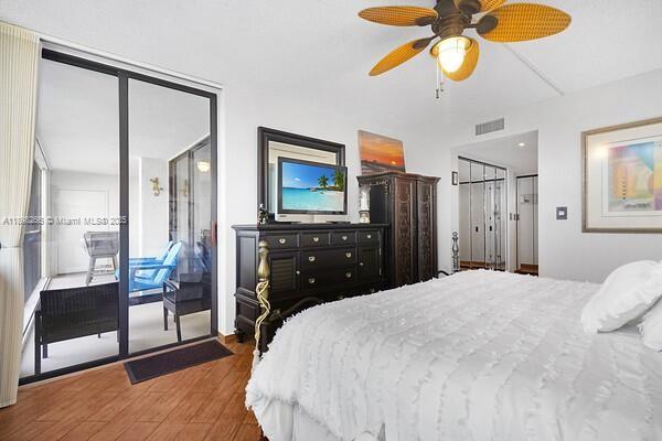 1605 Highway 1, Unit 403M3 Jupiter, FL 33477 - Photo 8 of 18 a bedroom with a bed and a chandelier