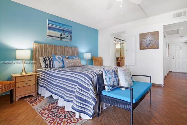 1605 Highway 1, Unit 403M3 Jupiter, FL 33477 - Photo 9 of 18 a bedroom with a bed and wooden floor