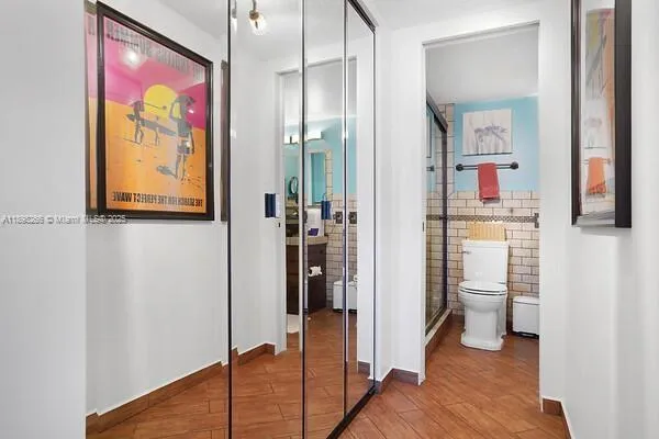 a view of a hallway with paintings on the wall