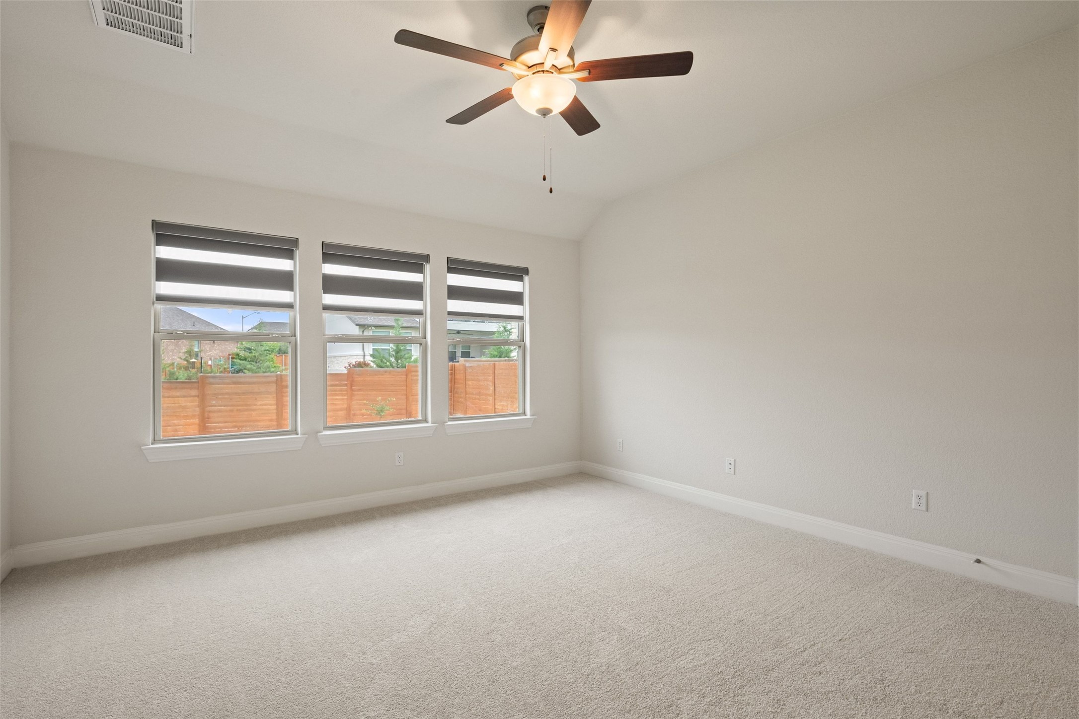 1513 Hinterwald Street Leander, TX 78641 - Photo 34 of 40 an empty room with a window and a fan