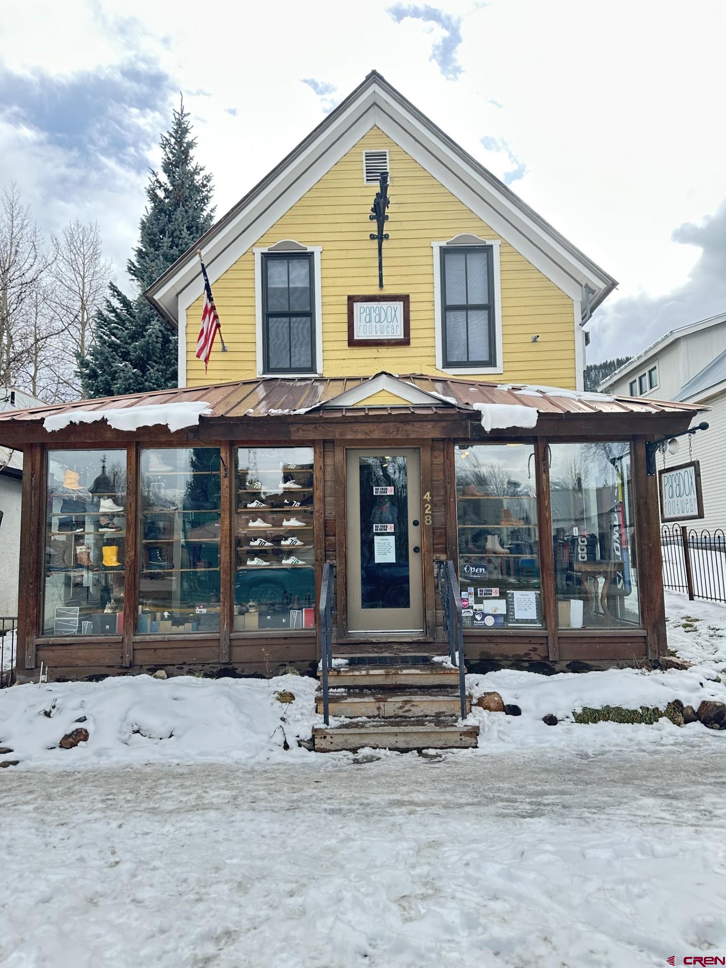 a view of a house with wooden fence