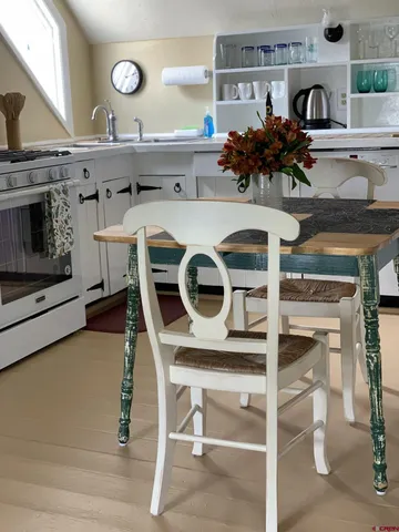 a kitchen with a stove a microwave and a table with chairs