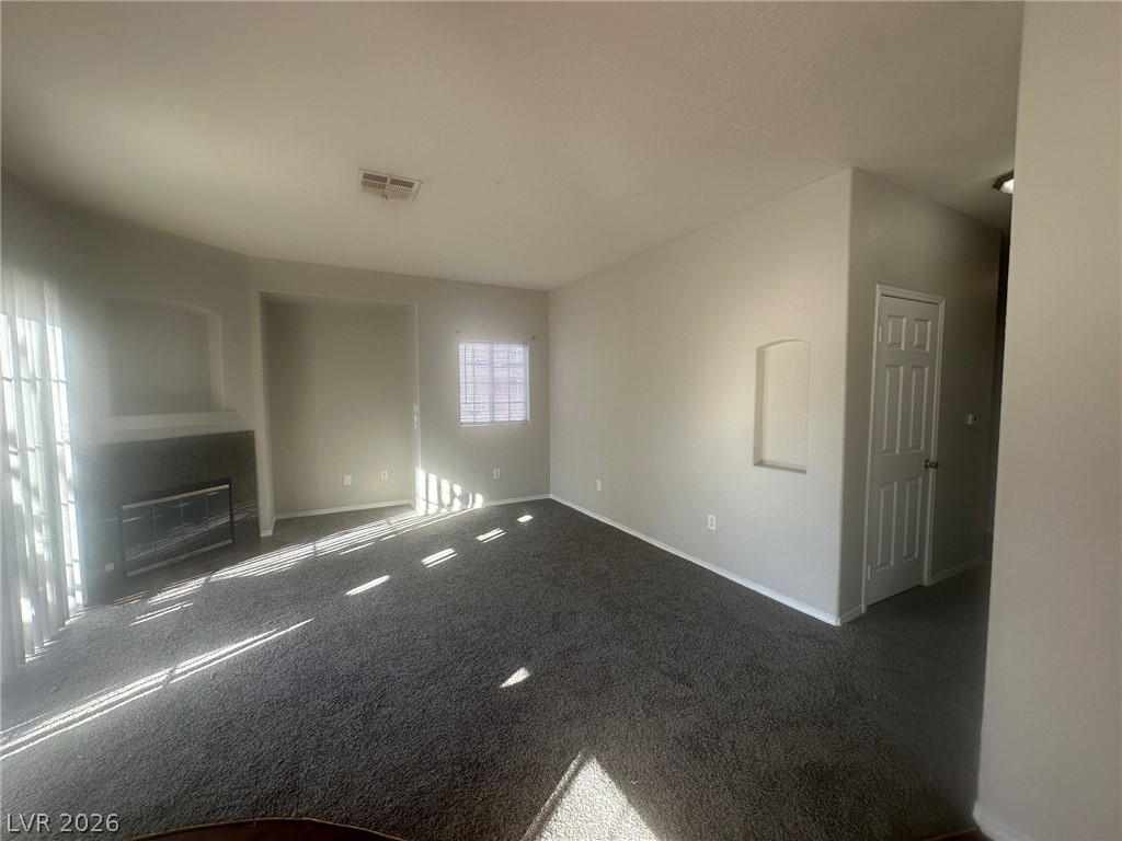 4730 East Craig Road, Unit 1073 Las Vegas, NV 89115 - Photo 3 of 18 An inviting fireplace accents this cozy living area detailed with recessed wall niches.