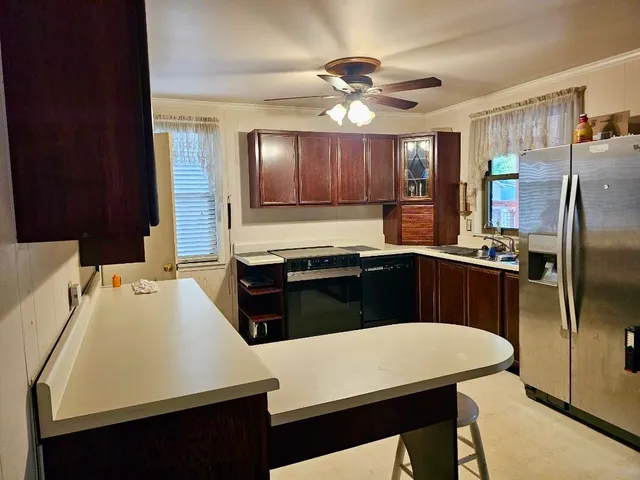 a kitchen with a appliances a sink and a refrigerator