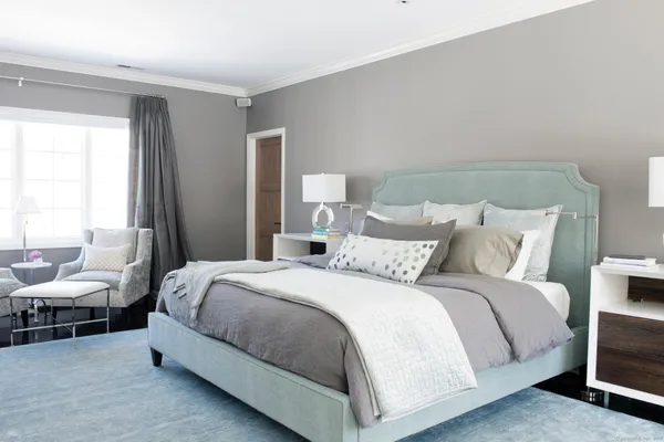 a bedroom with a bed and lamp