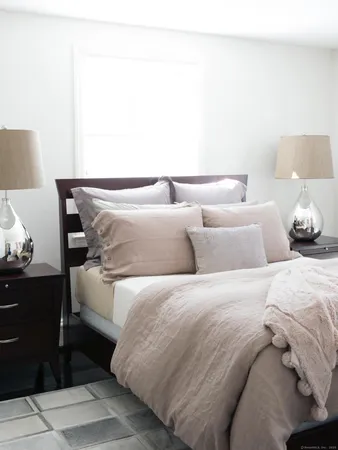 a bedroom with a bed and a night stand