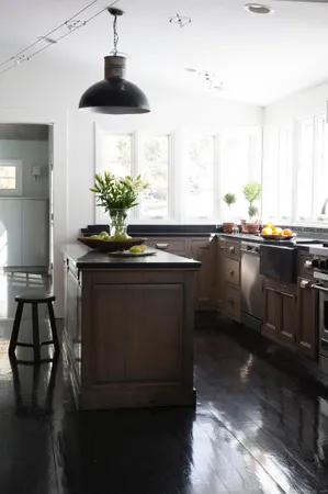 a kitchen with granite countertop a sink stainless steel appliances and cabinets