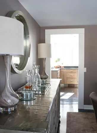 a dining room with wooden floor a glass table and chairs
